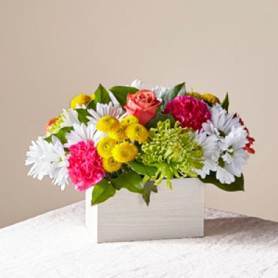 What's the scoop on this bright arrangement? Well, our Sorbet Bouquet is curated with a full serving of freshness and fragrance to make anyone's day sweeter.

This design features roses, spider mums, carnations and poms in a whitewashed wooden box.